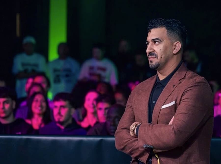 Anthony Girges, founder of Championing Mental Health, standing ringside with his arms crossed.
